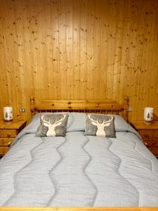 een groot bed in een kamer met houten wanden bij Altea Retreat in Ponte di Legno +11 foto's