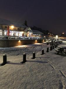 a row of benches in the snow at night at Half Moon Jackfield in Bridgnorth