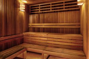 a sauna with wooden walls and benches in a room at Thalazur Carnac in Carnac