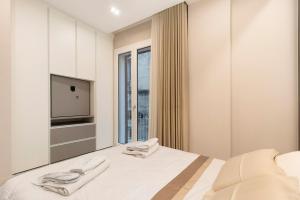 En eller flere senge i et værelse på Ginex Luxury Suite, Trani