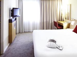a hotel room with a bed and a television at Novotel Sheffield Centre in Sheffield