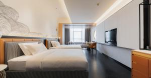 TV a/nebo společenská místnost v ubytování Starway Hotel Chengdu Longquan Economic Port Baiyunxi