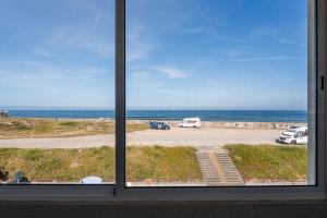 a view of the ocean from a window at Charming Beachside Escape in Esmoriz