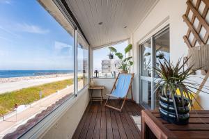 a balcony with a view of the beach at Charming Beachside Escape in Esmoriz