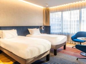 Una cama o camas en una habitación de Novotel Campo De Las Naciones