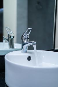 a sink with a faucet in a bathroom at Sleeping Warrior Camp Elementaita in Nakuru +34 photos