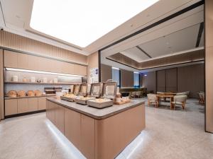 eine Lobby der Kapelle mit einem Tisch und Stühlen in der Unterkunft JI Hotel Chengdu Sichuan Normal University in Chengdu