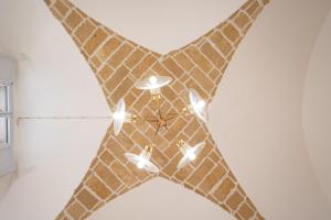 a brown star shaped clock on a wall at Palazzo Celina in Gallipoli +32 photos