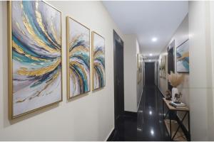 a hallway with five paintings on the walls at Via Ganpati 2 - Nr Siliguri Junction in Siliguri