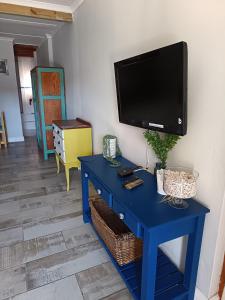 a blue table with a tv on a wall at Bluewater Guesthouse in Port Elizabeth