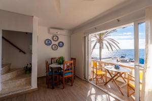 a dining room with a view of the ocean at Casa Abril by Escape Home in S'Algar