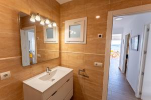 a bathroom with a sink and a mirror at Casa Abril by Escape Home in S'Algar +17 photos