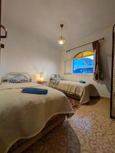 Ένα ή περισσότερα κρεβάτια σε δωμάτιο στο DAR Dunia Panoramic terrace