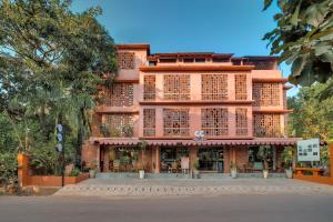a tall building with a store in front of it at Unseen Boutique Hotel, Assagao in Assagao