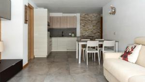 a kitchen and living room with a table and chairs at Zardin 7 in Valdidentro