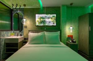 a bedroom with a large bed and a sink at Pynt Hotel 7 in Ho Chi Minh City