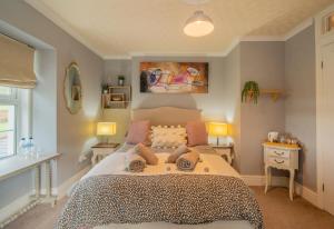 a bedroom with a large bed and two lamps at YR HEN FICERDY in Aberystwyth