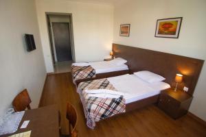 Postel nebo postele na pokoji v ubytování Hotel Lux