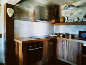 a kitchen with wooden cabinets and a stove top oven at WoodHouse Homestay Chiangrai in Ban Pha Lae Nua +39 photos