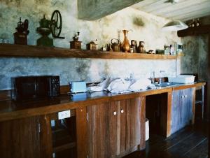 a kitchen with a wooden counter with a microwave at WoodHouse Homestay Chiangrai in Ban Pha Lae Nua