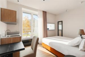 a hotel room with a bed and a sink at Whitlock16 - Luxe Aparthotel Montgomery Square Brussels in Brussels