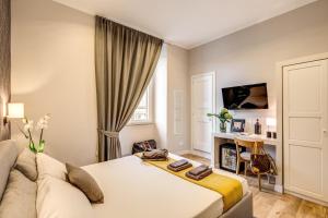 a bedroom with a bed and a couch at The Club Navona in Rome