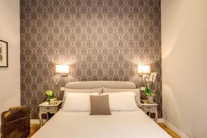 a bedroom with a bed and two tables with lamps at The Club Navona in Rome