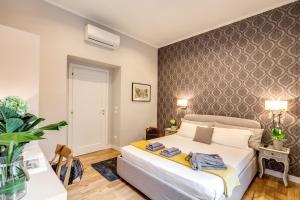 a bedroom with a bed in a room with a wall at The Club Navona in Rome