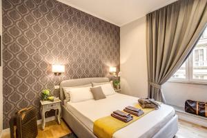 a bedroom with a bed in a room with a window at The Club Navona in Rome