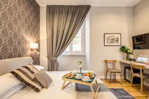 a living room with a bed and a table with fruit on it at The Club Navona in Rome