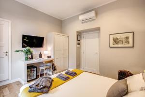 a bedroom with a white bed and a desk at The Club Navona in Rome