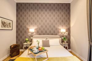 a bedroom with a bed and a table with fruit on it at The Club Navona in Rome
