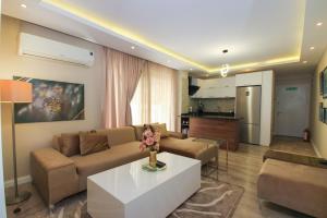 a living room with a couch and a table at Metropolitan Art in Altınkum