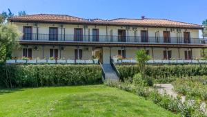 a large house with a garden in front of it at Arvanitakis Studios in Tragaki