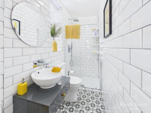 a white bathroom with a sink and a toilet at The Cask Room in Scarborough