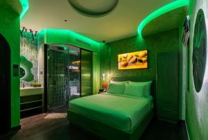 a green bedroom with a bed and a shower at Pynt Hotel 7 in Ho Chi Minh City