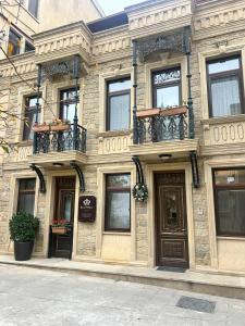 a stone building with balconies on a city street at Antique Royal Hotel in Baku