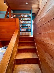 a staircase in a house with wooden walls at カタツムリ in Shiogama