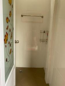 a bathroom with a shower with a glass door at Kubu home stay in Ban Ko Sawat +24 photos