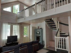 un soggiorno con una scala e un divano di Sunski a Syöte