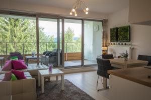 a living room with a couch and a table at Apartment Mountain Panorama in Wisła