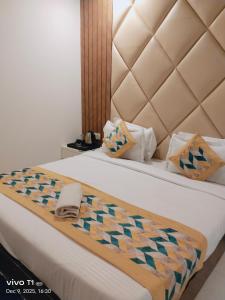 a hotel room with a bed with a quilt on it at Tejas stay in New Delhi