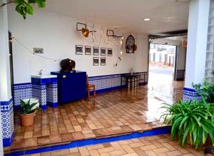 a room with blue and white walls and a tile floor at DescubreHome La Casa del Medico in Aznalcázar