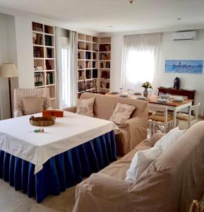 a living room with a couch and a table and a dining room at DescubreHome La Casa del Medico in Aznalcázar