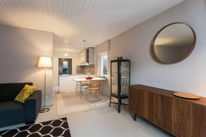 a living room with a couch and a mirror at Haus am Sagenweg in Nothweiler