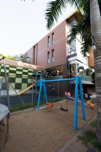 a playground in front of a building with a palm tree at The Pearl In City by WOW Property - Direct from developer in Accra