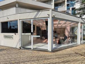 a conservatory with sliding glass doors in front of a building at Flat Expo Anhembi WiseSP Accommodations in São Paulo