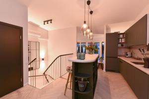 a kitchen with a island in the middle of a room at Penthouse Mountain and Lake View, terrace, AirCondition, incl Summer Card in Zell am See