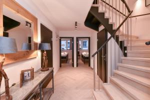 a hallway with stairs leading to a living room at Penthouse Mountain and Lake View, terrace, AirCondition, incl Summer Card in Zell am See