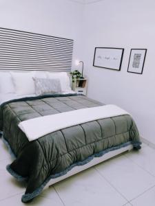 a large bed in a bedroom with a white wall at Marinella House Napoli centro Piazza Dante in Naples